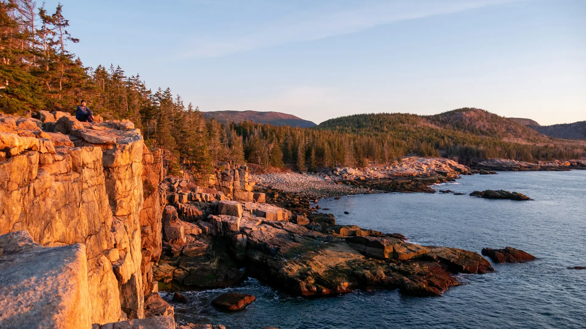 A rocky cliff overlooks a body of water