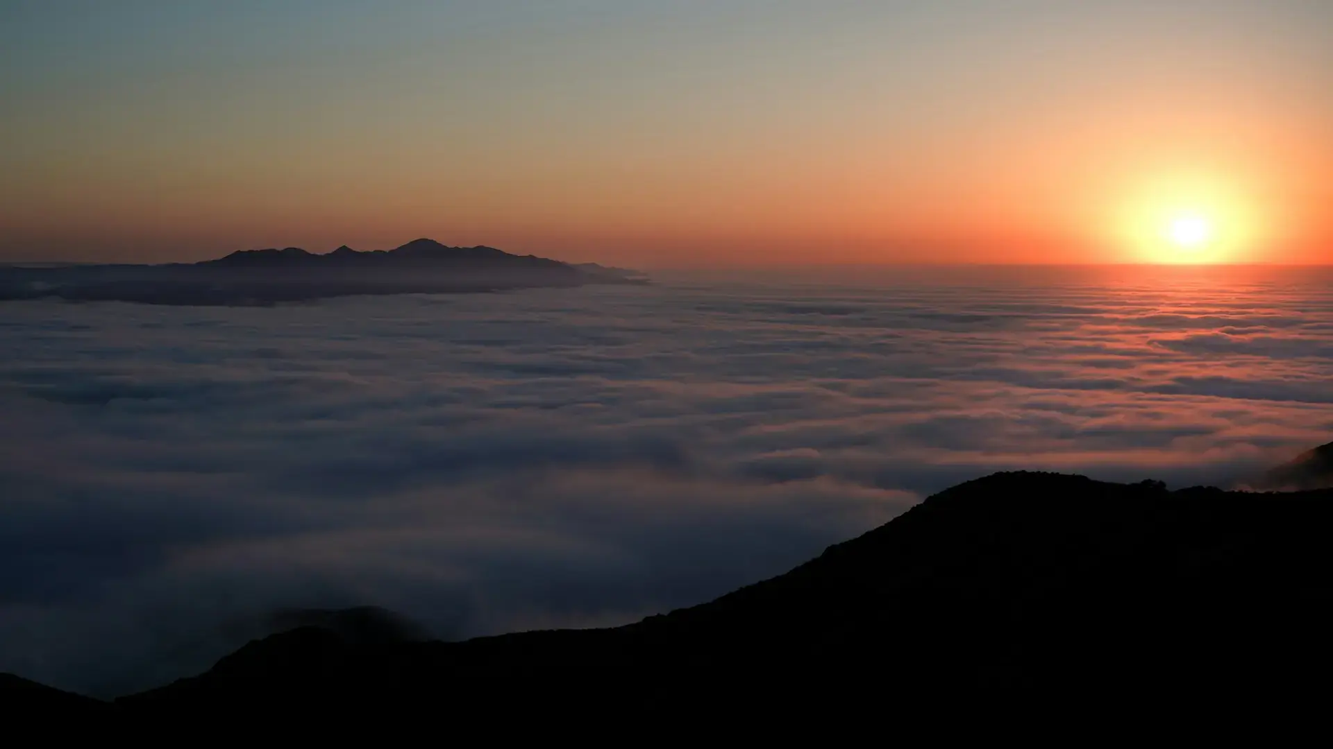 Sunset above coastal fog on Santa Cruz Island in Channel Islands National Park.