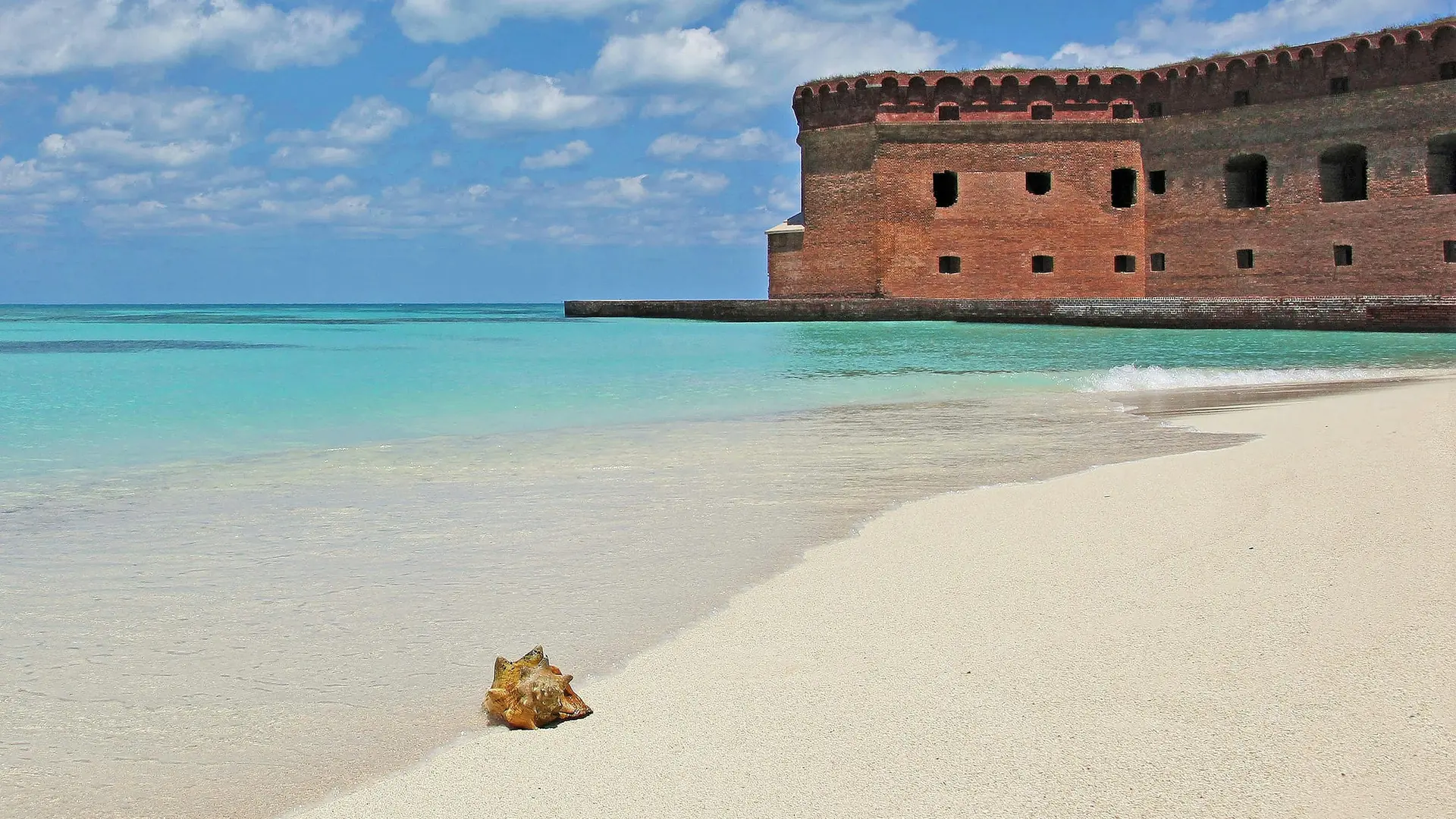 Brown concrete building on beach during daytime
