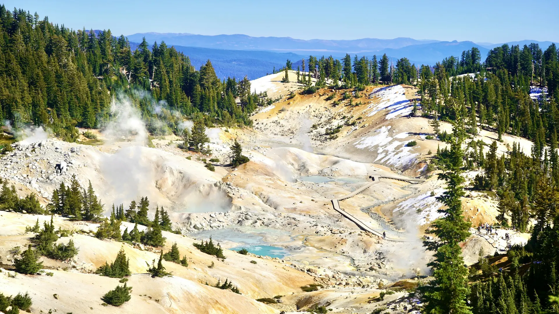 Pale mineral deposits and steaming hydrothermal vents at Lassen Volcanic National Park.