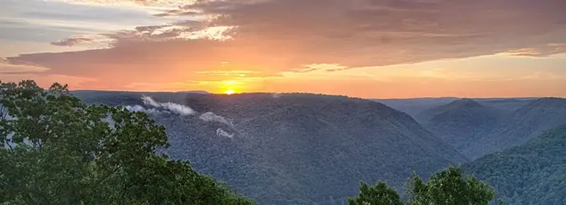 sun setting over a deep gorge