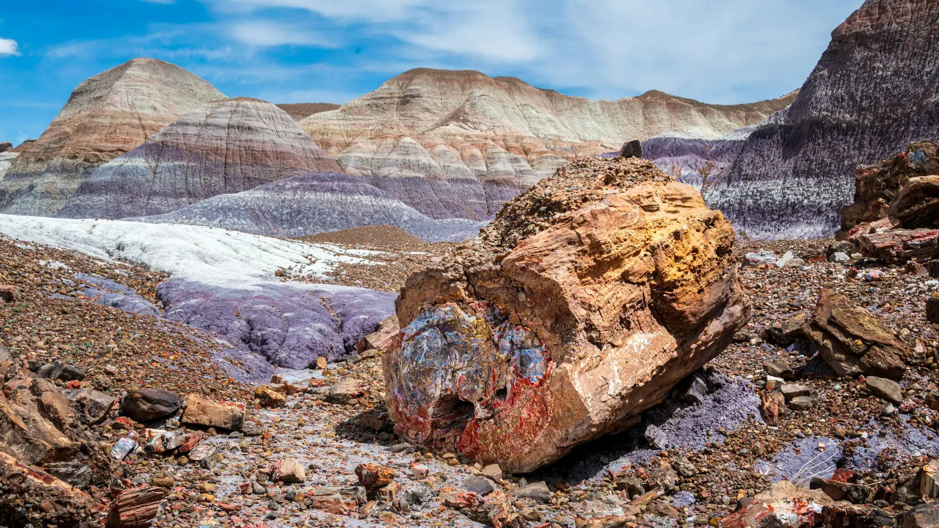 A large rock sitting on top of a rocky hillside