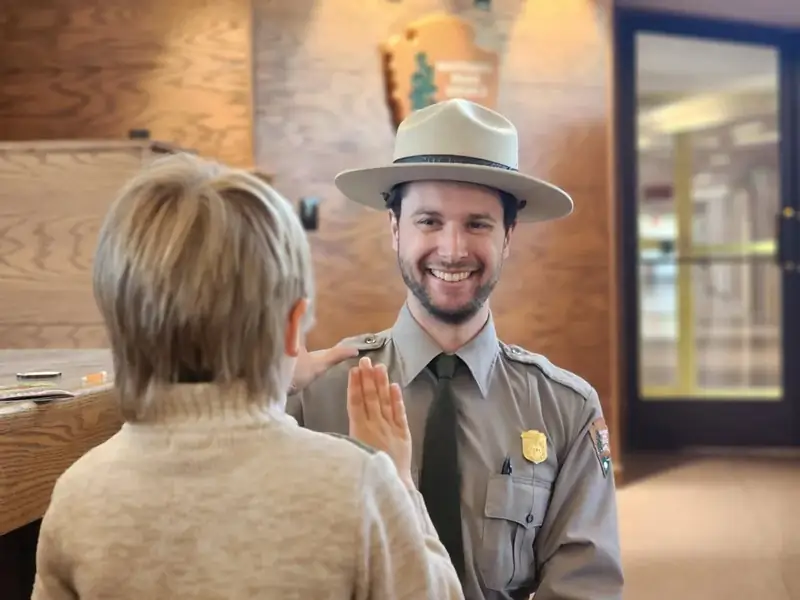 A park ranger is swearing in a new Junior Ranger